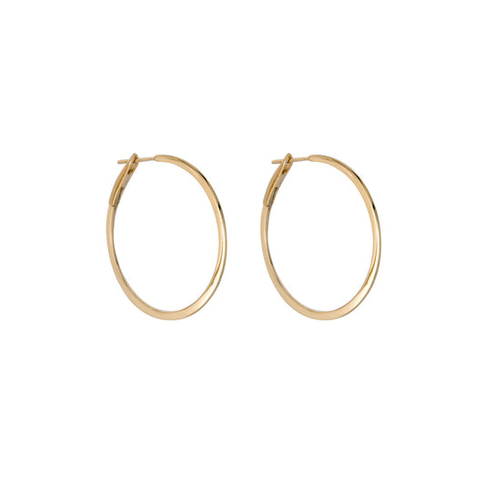 Side view of 1 1/4-inch skinny solid 14k gold hoop earrings, lightweight everyday hoops by Phoenix Roze
