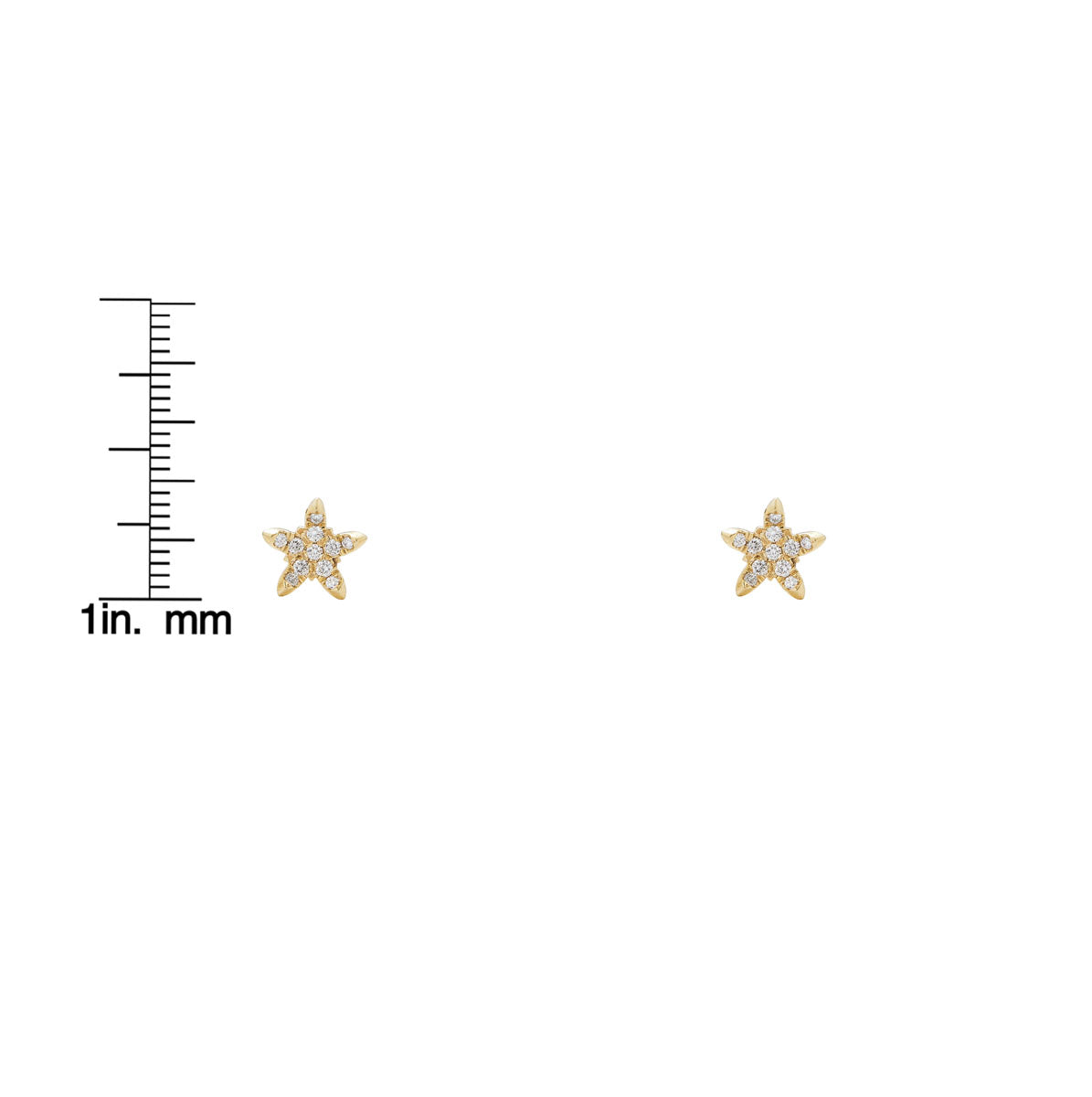 Curved diamond star earrings shown on a measurement scale for size reference; delicate celestial ear climbers.
