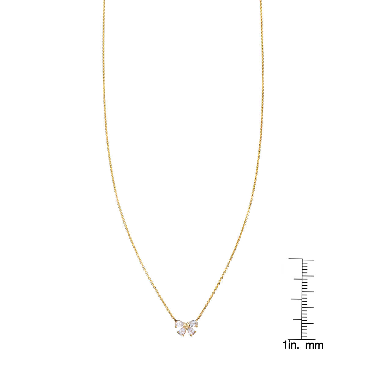 Diamond bow pendant necklace by Phoenix Roze shown with ruler for scale on delicate gold chain