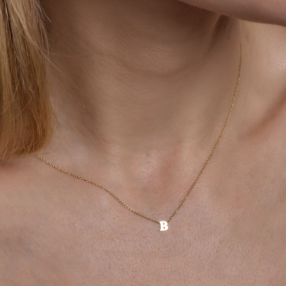Complete your look with a gold initial necklace, a stunning addition to your ensemble.