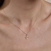 Dainty gold anchor necklace on woman's neck, delicate nautical pendant, Phoenix Roze fine jewelry