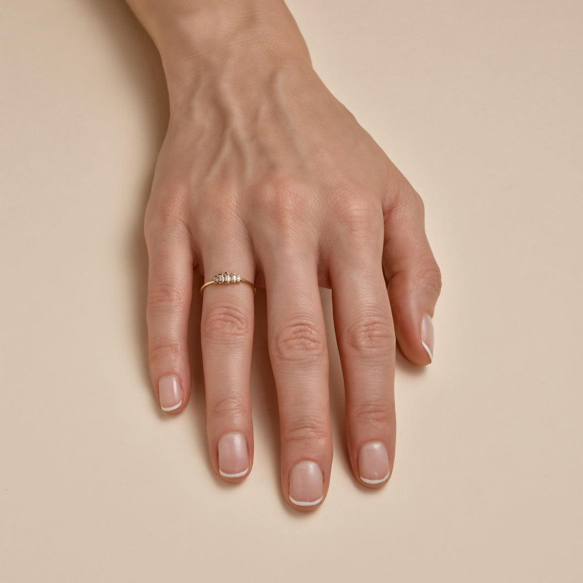 Gold Art Deco diamond ring on woman's finger, vintage-inspired engagement jewelry by Phoenix Roze