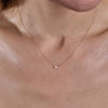 Gold diamond rectangular pendant necklace worn on model's neck, delicate fine jewelry by Phoenix Roze