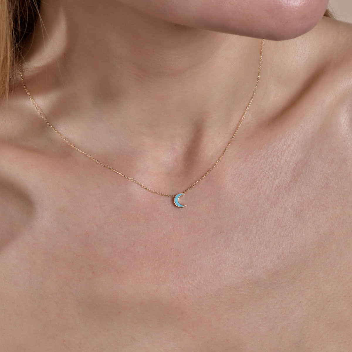 Gold turquoise moon pendant necklace on model's neck | Phoenix Roze
