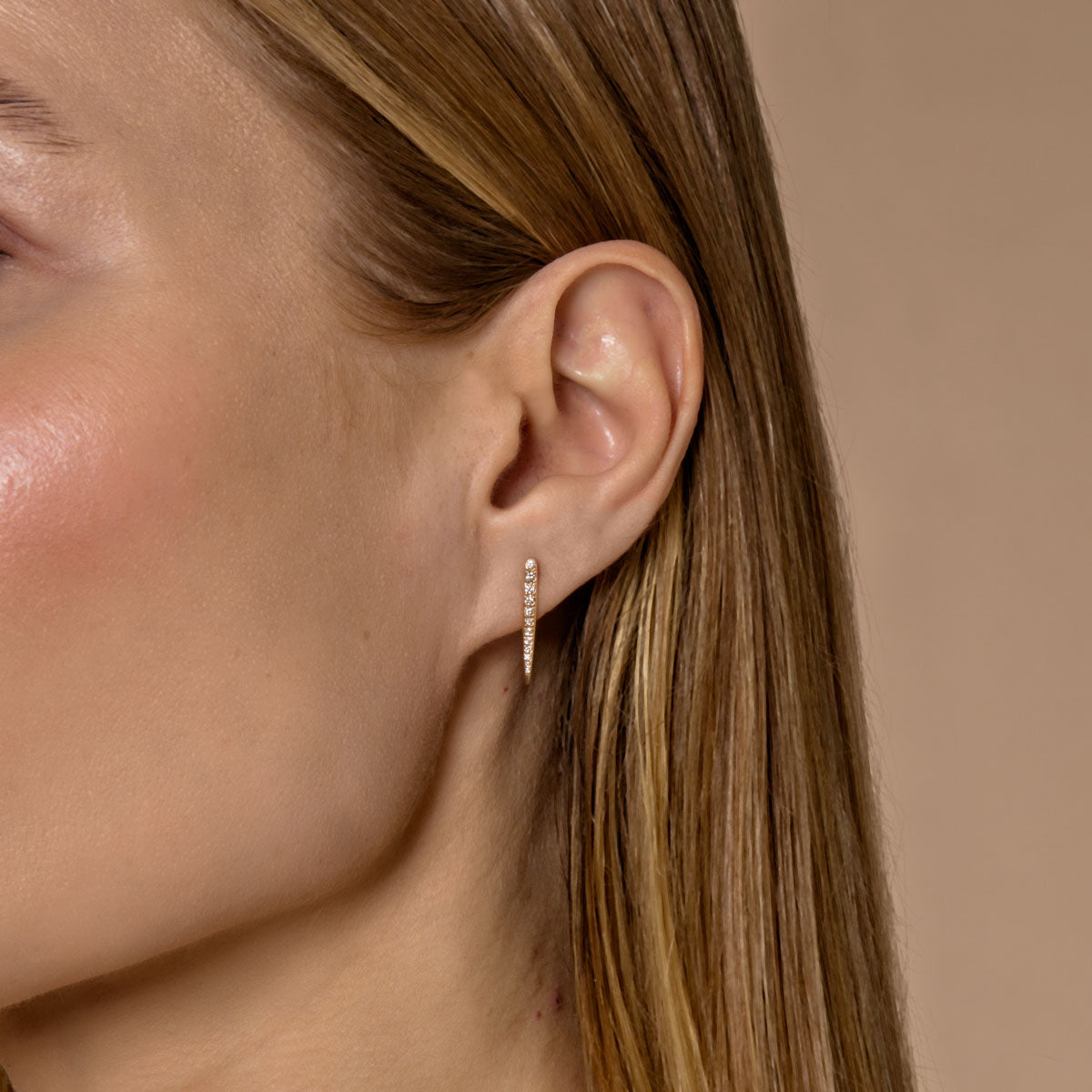 Model wearing diamond long drop large stud earrings by Phoenix Roze