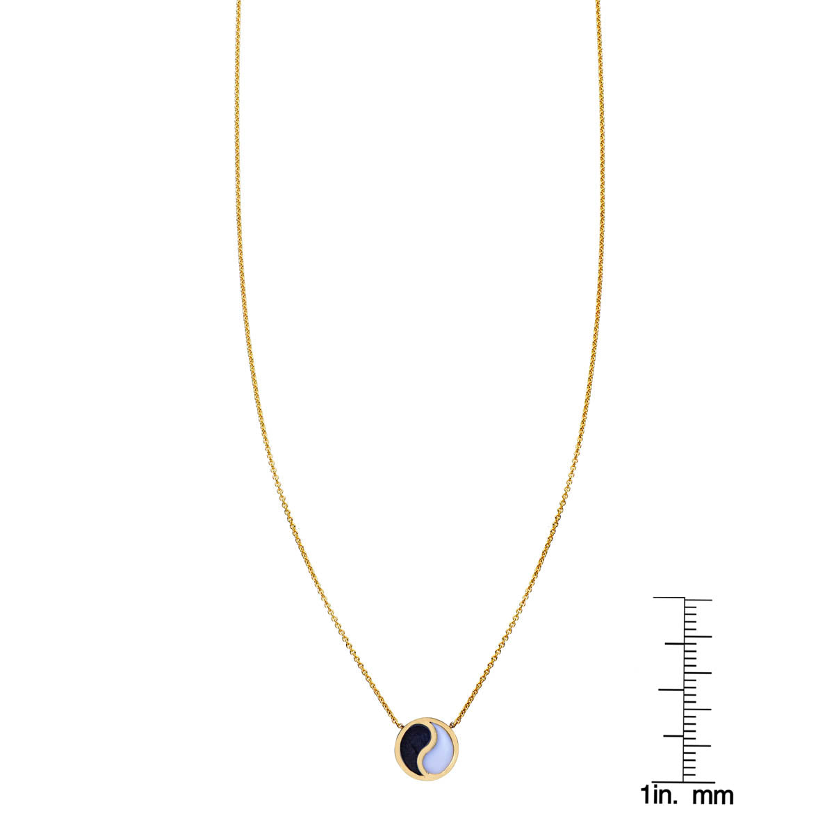 Onyx and white jade yin-yang pendant necklace shown next to a ruler for scale, Phoenix Roze fine jewelry