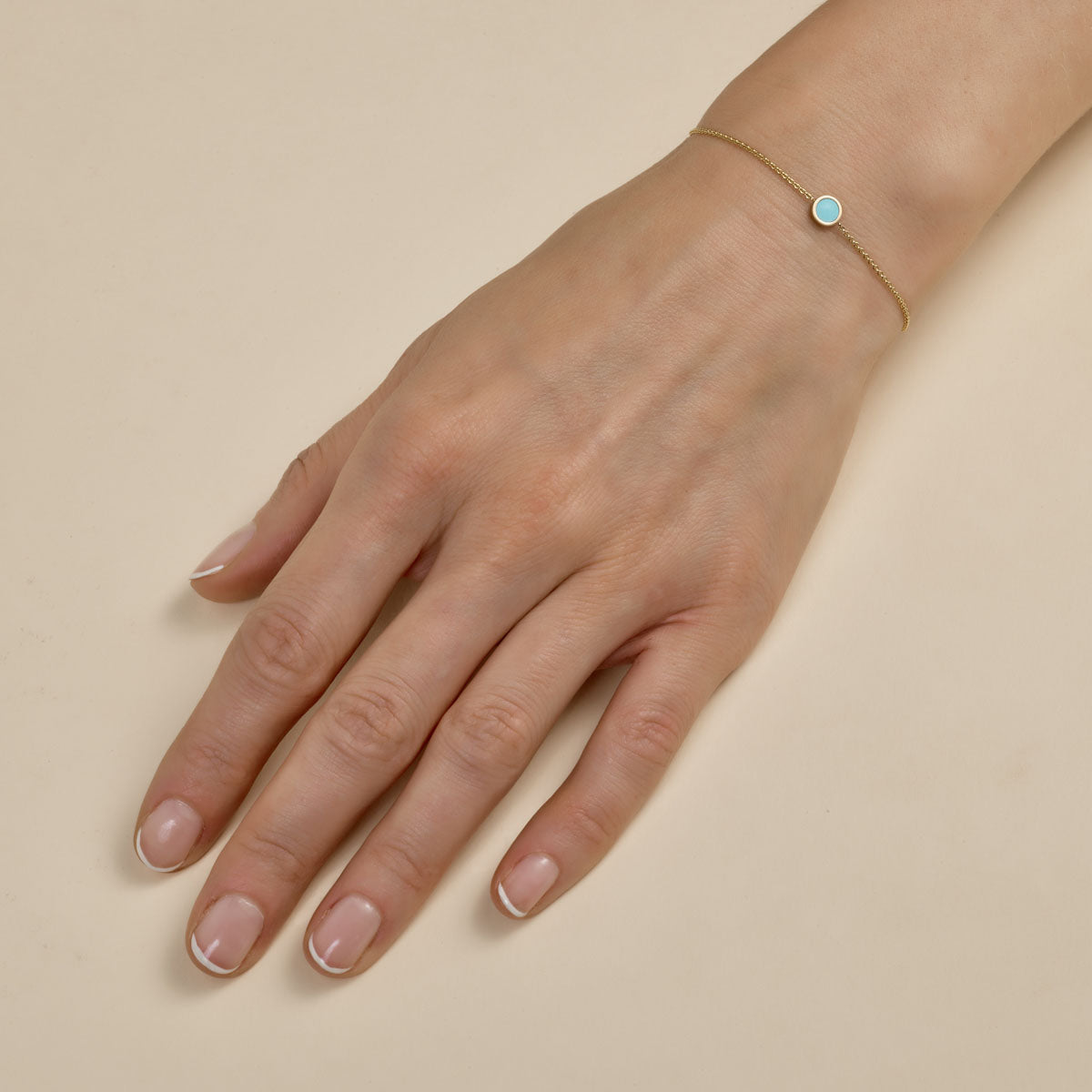 Round turquoise and gold bracelet on woman's wrist, handcrafted fine jewelry by Phoenix Roze