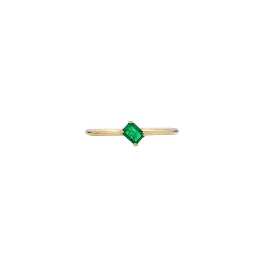 Sideways emerald baguette ring on gold band—vivid green gemstone in yellow, white, or pink gold setting.