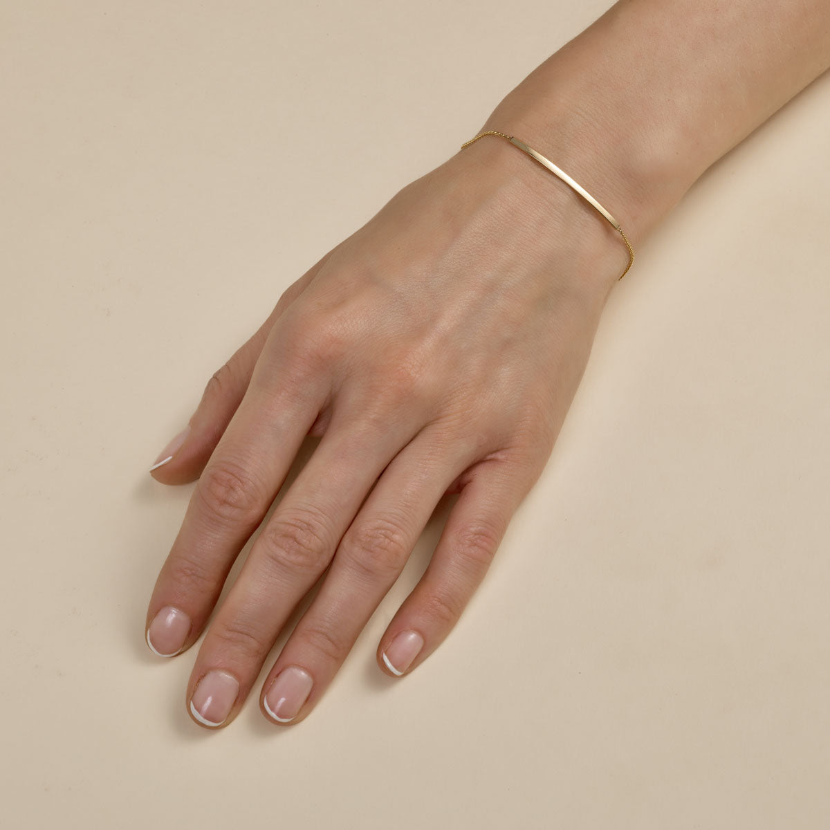 Dainty 14k gold bangle - minimalist modern bracelet on woman's wrist