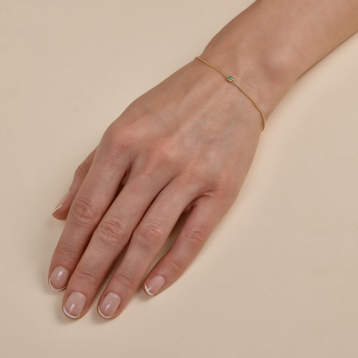 Phoenix Roze square-cut sapphire and gold bracelet on a woman's hand, elegant fine jewelry