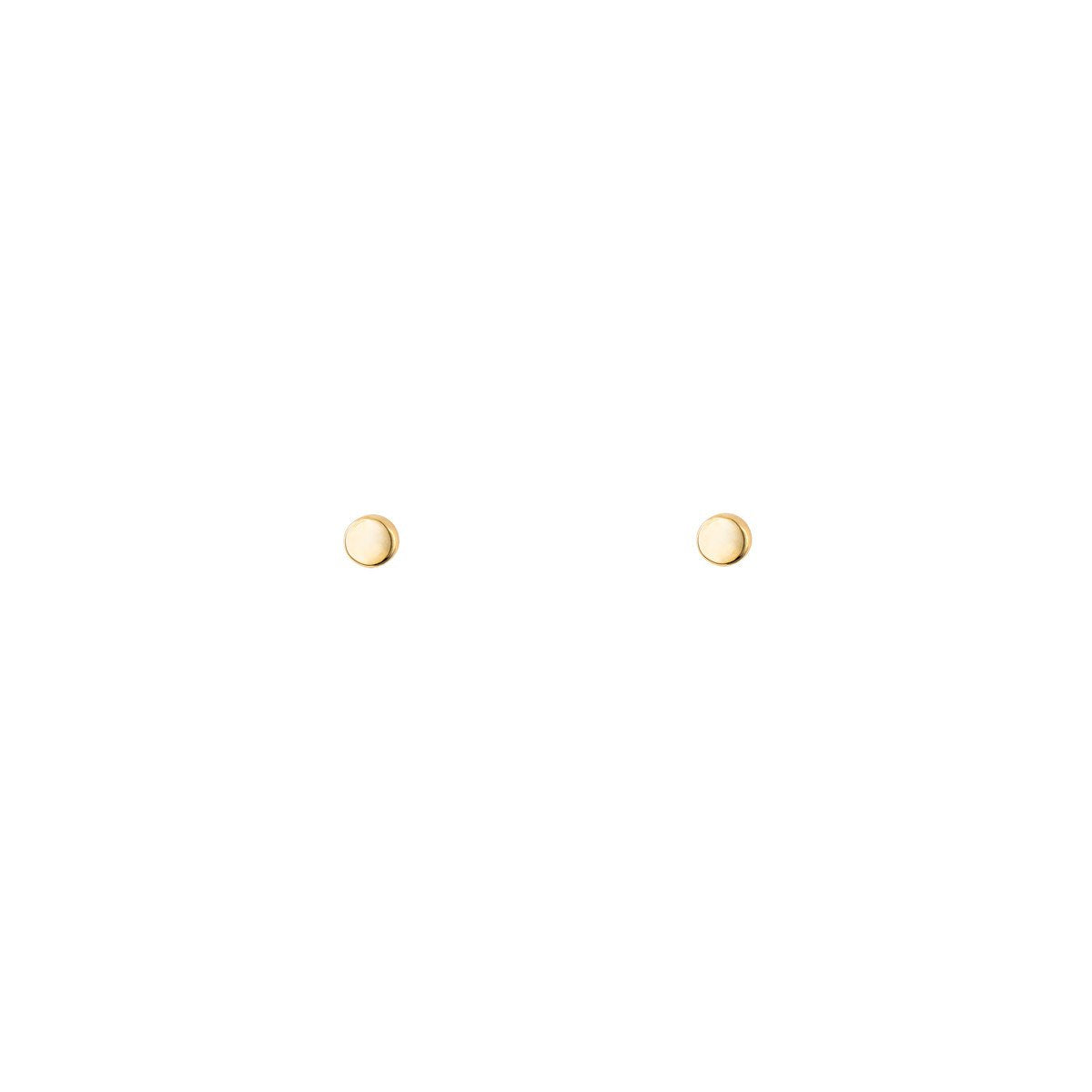 Tiny gold dot stud earrings in solid 14k yellow gold—minimalist, lightweight everyday studs.