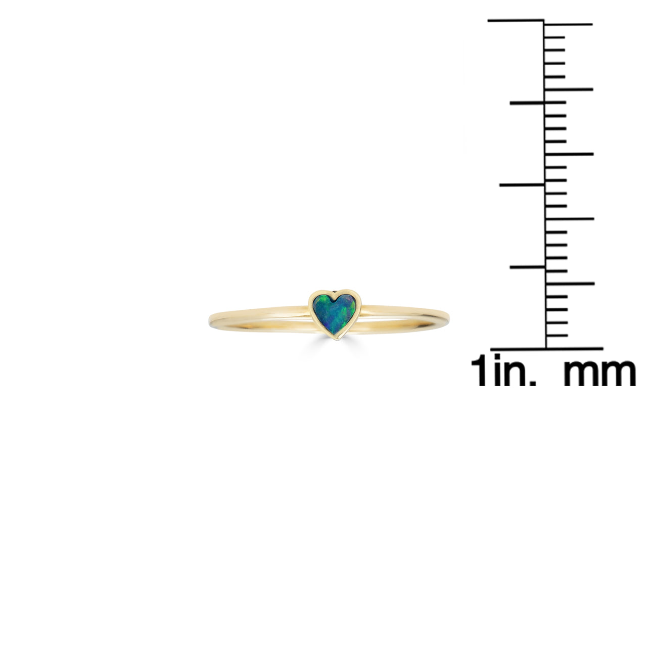 Close-up of tiny opal inlaid heart ring on a delicate band, fine jewelry detail