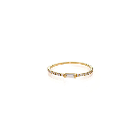 White baguette diamond ring featuring a 5mm baguette-cut diamond on a delicate pave gold band; sleek, modern fine jewelry.