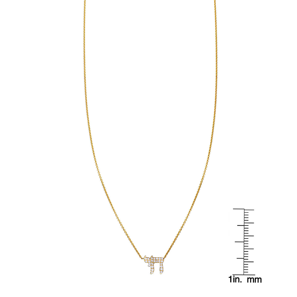 White diamond Chai necklace next to a ruler for scale, delicate Jewish pendant on fine chain