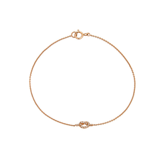 Dainty 14k gold love knot bracelet with pave white diamonds—romantic gift from Phoenix Roze