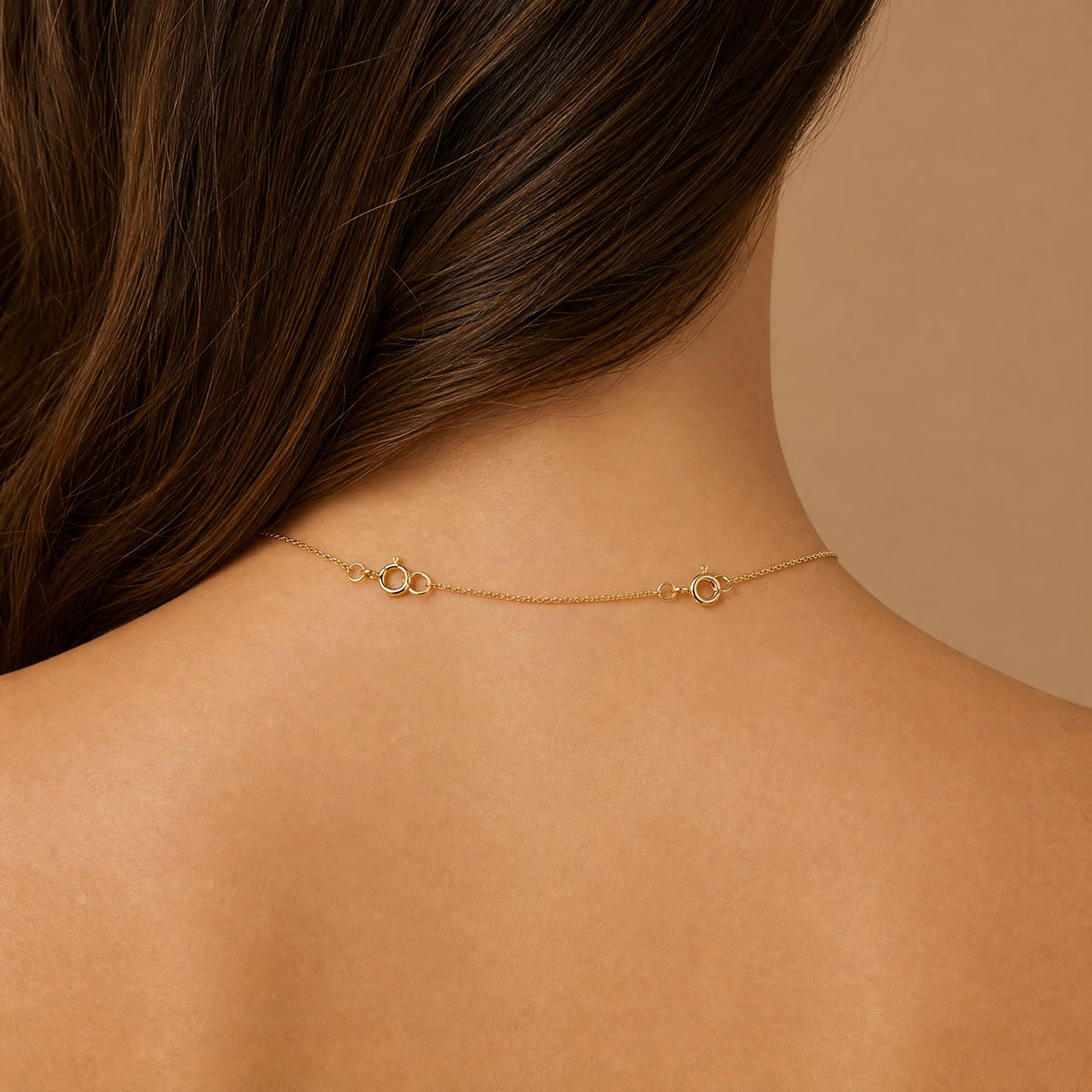 14k gold necklace extender worn on model showing spring ring clasps at back of neck