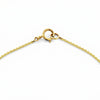 Close-up of 14k yellow gold spring ring clasp on fine chain necklace