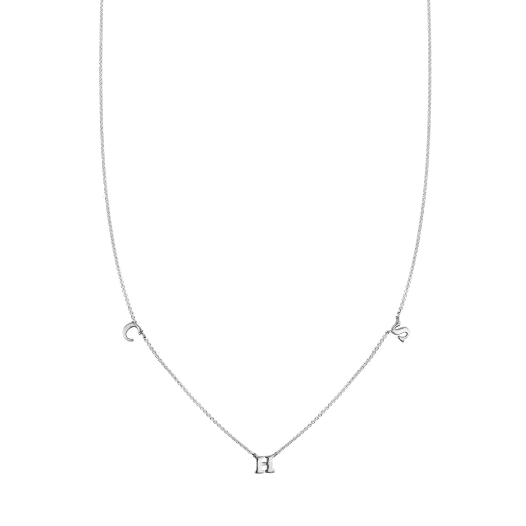 Custom three-letter sterling silver initial necklace with spaced 'C', 'H', and 'S' charms.