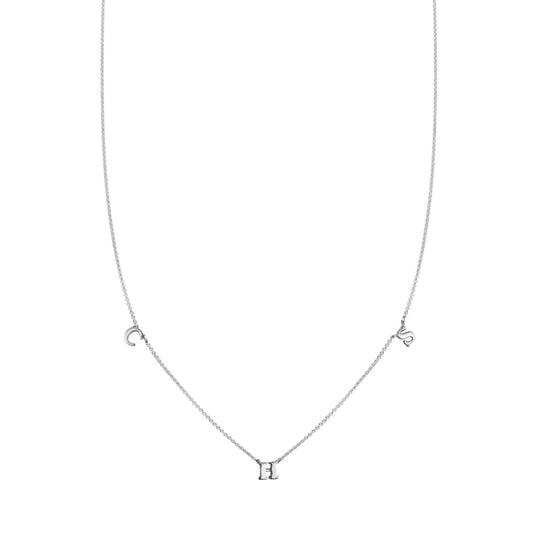 Custom three-letter sterling silver initial necklace with spaced 'C', 'H', and 'S' charms.