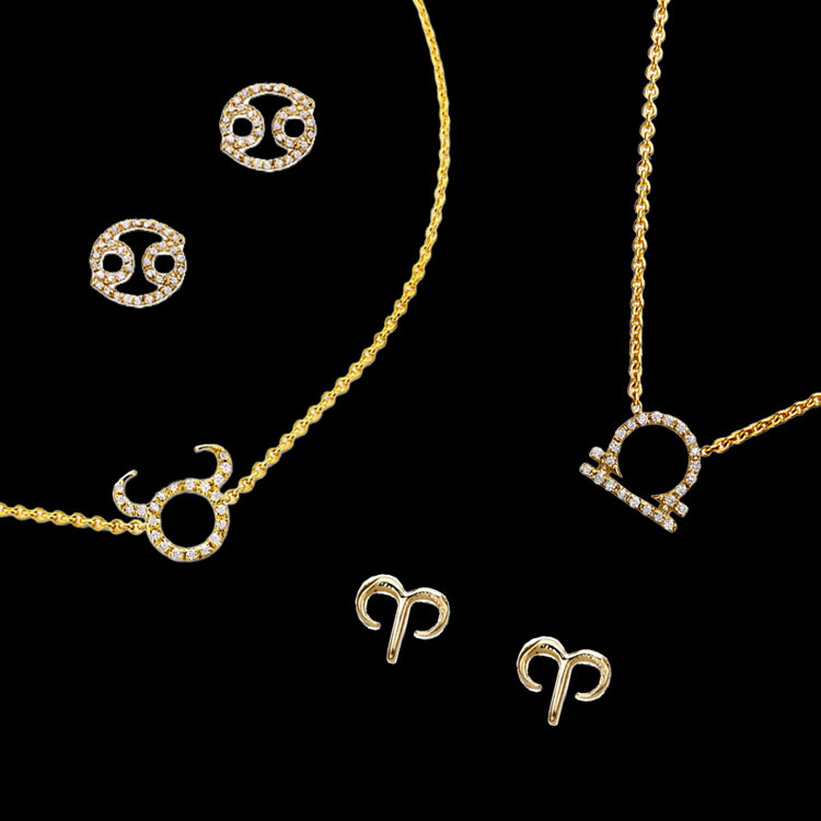 Diamond zodiac jewelry featuring Cancer stud earrings, a Taurus necklace, a Libra necklace, and Aries stud earrings, all in gold