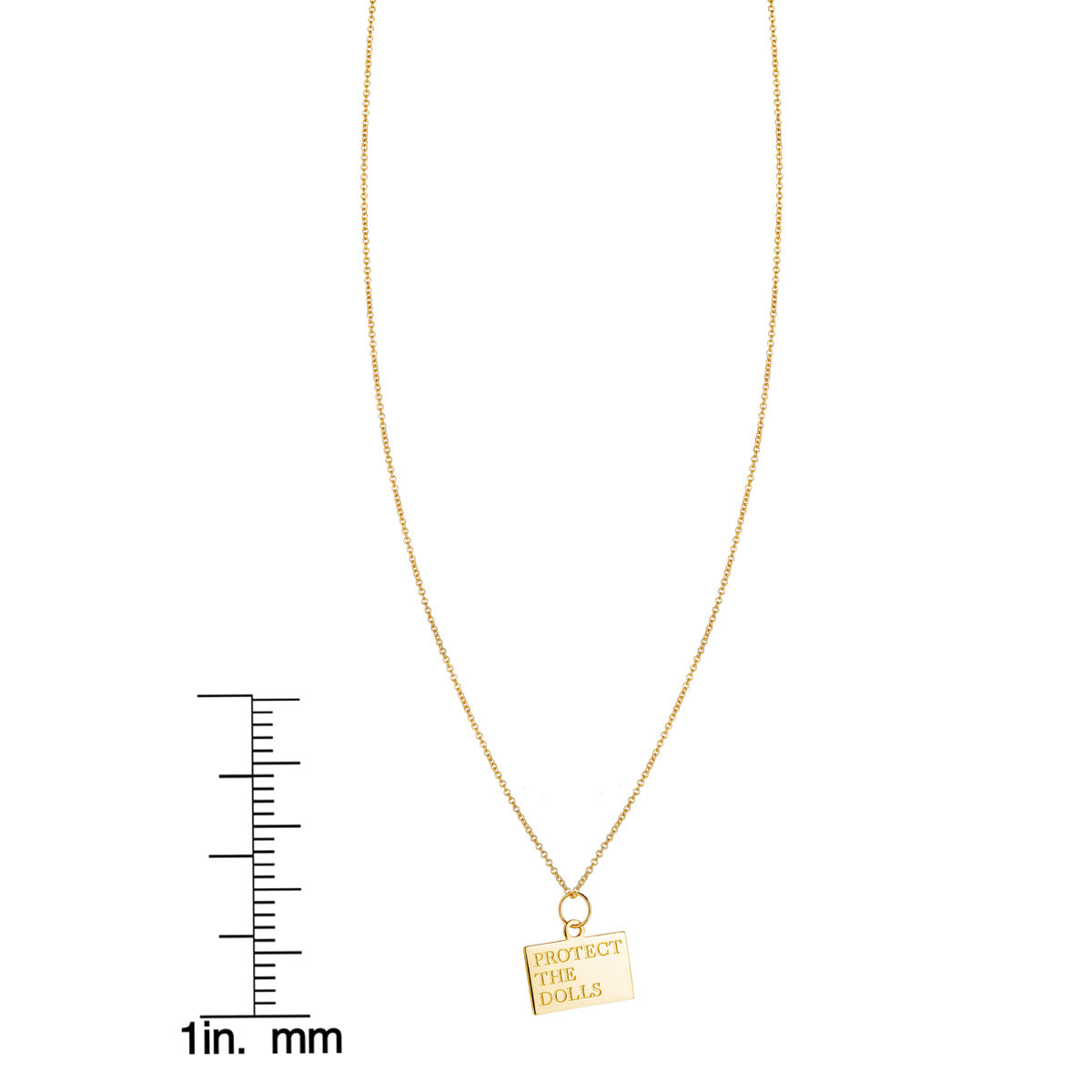 Protect the Dolls gold pendant necklace shown next to inch and millimeter ruler for size reference