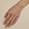 Cursive gold love script bracelet - elegant romantic jewelry on woman's wrist