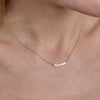 Cursive gold name necklace - personalized script pendant on woman's neck