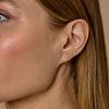 Close-up of diamond eyelash stud earrings on model, delicate sparkle on lobe, dainty fine jewelry by Phoenix Roze