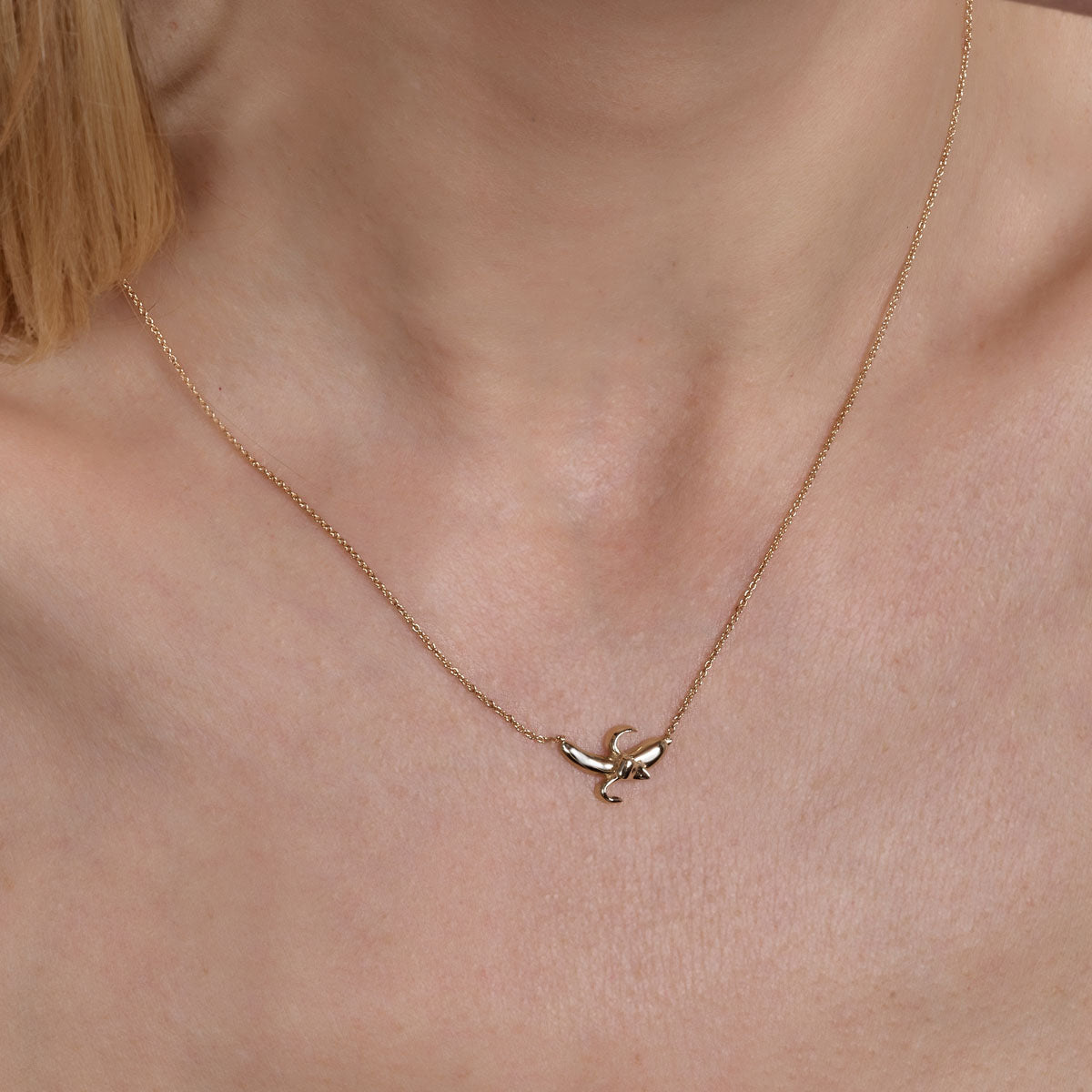 gold banana necklace on models neck