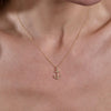 gold diamond anchor necklace on neck