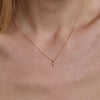 gold diamond cross necklace on neck