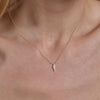 gold diamond lightning necklace on neck