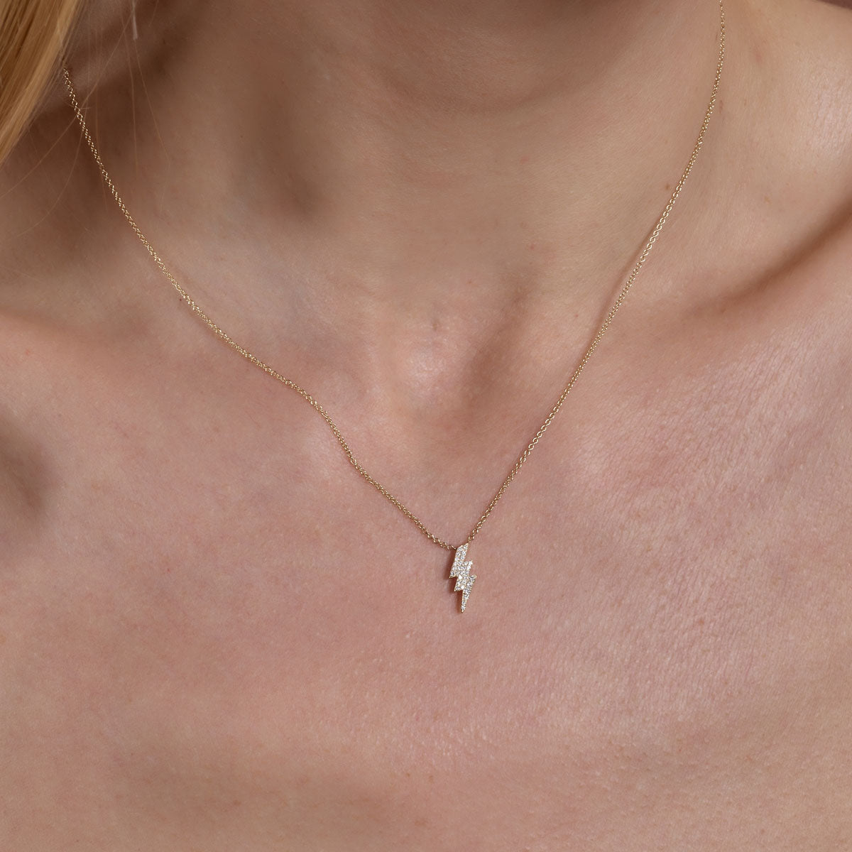 gold diamond lightning necklace on neck