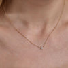 gold diamond star necklace on womans neck