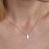 gold lightning necklace on womans neck