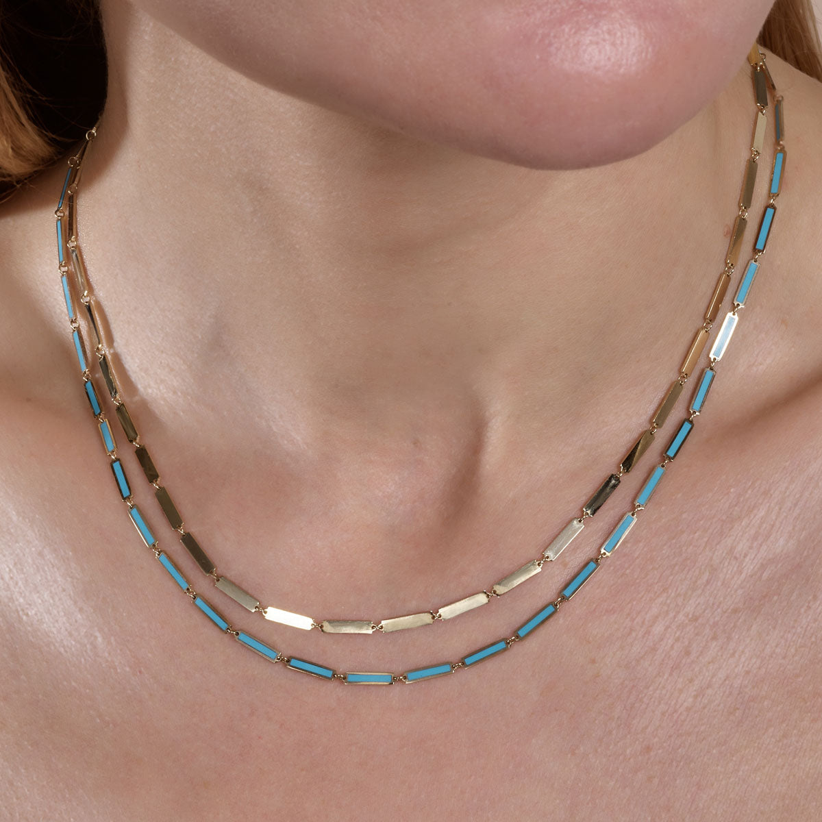 gold long bar links necklace and gold turquoise long bar links necklace on models neck