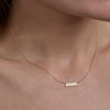 gold mom necklace on womans neck