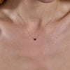 gold ruby heart necklace on neck