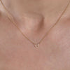 Gold Taurus necklace on woman's neck - personalized zodiac layering jewelry