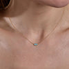 gold turquoise evil eye necklace on models neck