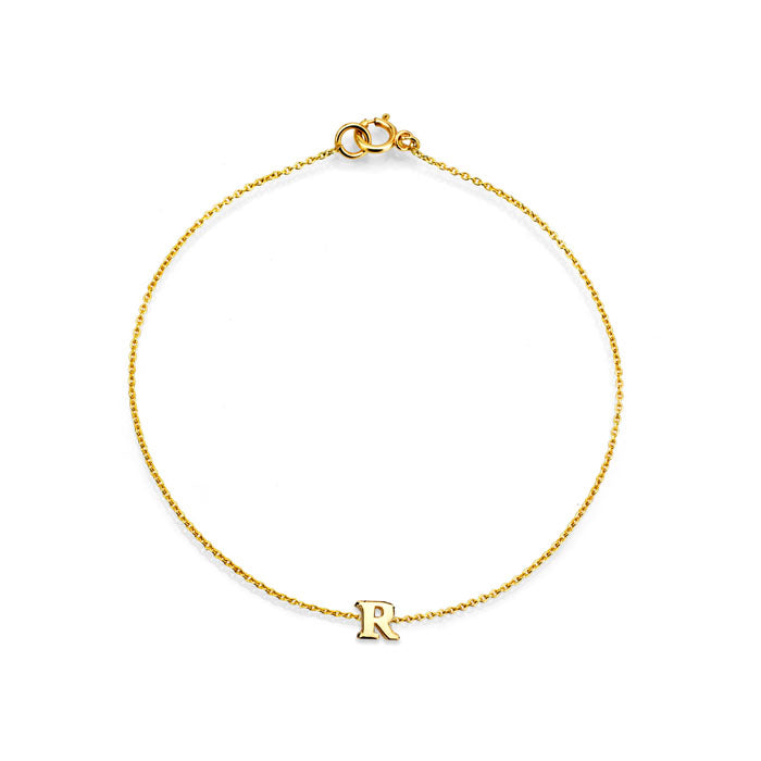 Complete your look with Phoenix Roze's stylish initial letter gold bracelet.