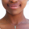 large turquoise bar necklace on womans neck
