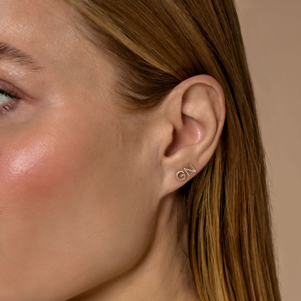 model wearing 14k gold diamond initial stud earrings