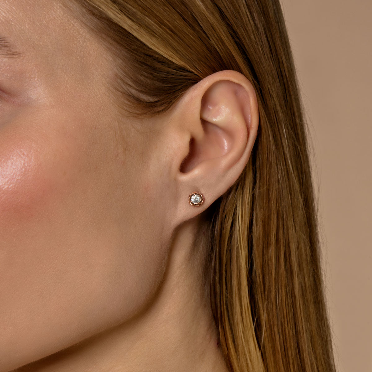 model wearing large diamond lotus flower earrings
