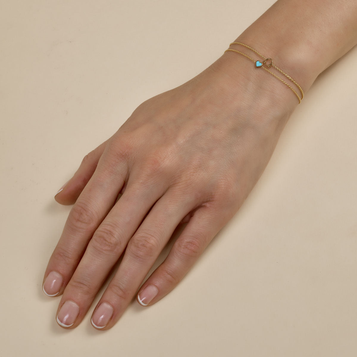 Layered gold and diamond bracelets - luxurious stacked jewelry on woman's wrist