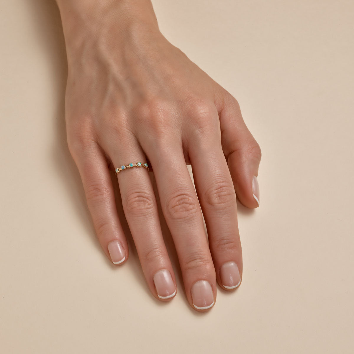 opal stackable band on womans finger