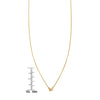 Petite gold butterfly necklace next to a ruler for scale and size details