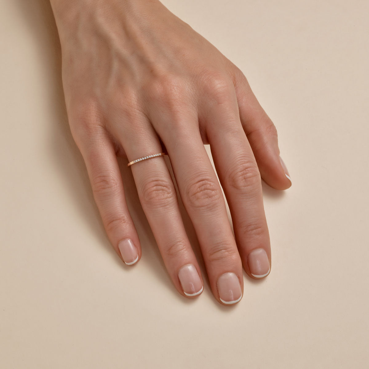 thirteen diamond gold ring on womans finger