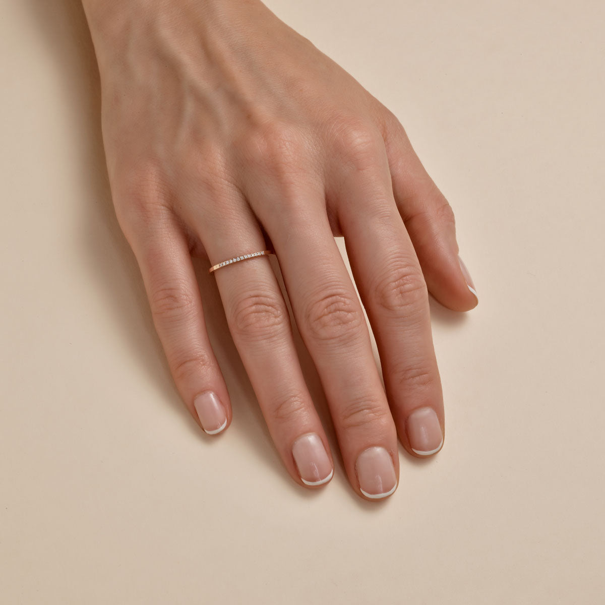 Delicate gold band with thirteen tiny diamonds - sparkling eternity ring on finger