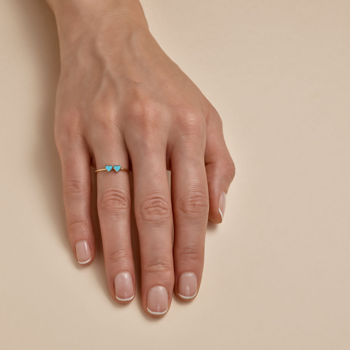 Turquoise double heart gold ring - unique boho-chic jewelry on woman's finger